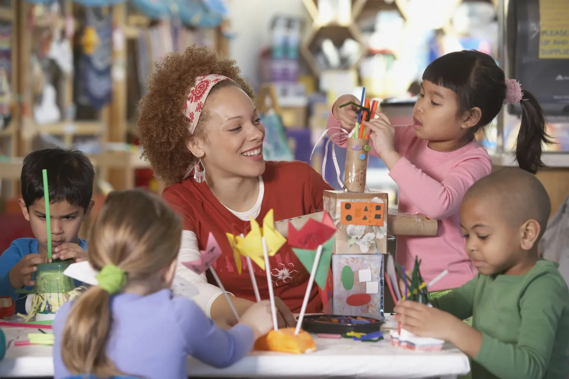 Caregiver doing a craft activity with young children