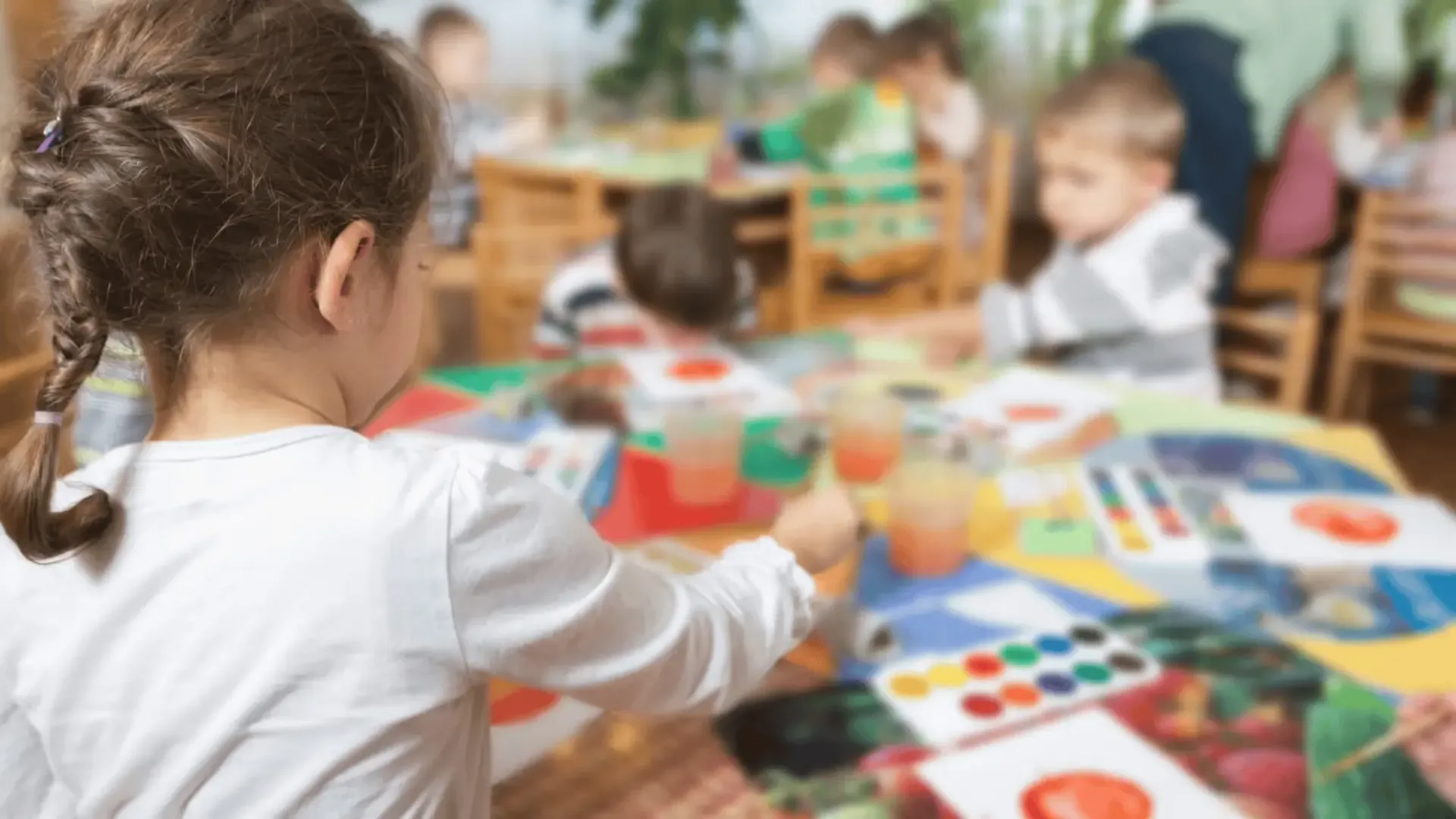 Children painting together at a table