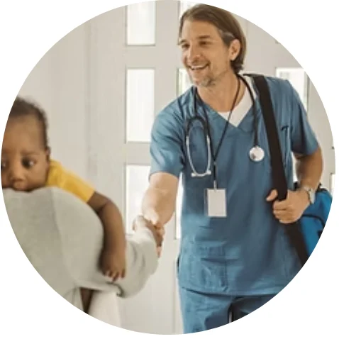 Home nurse smiling as he greets a young child