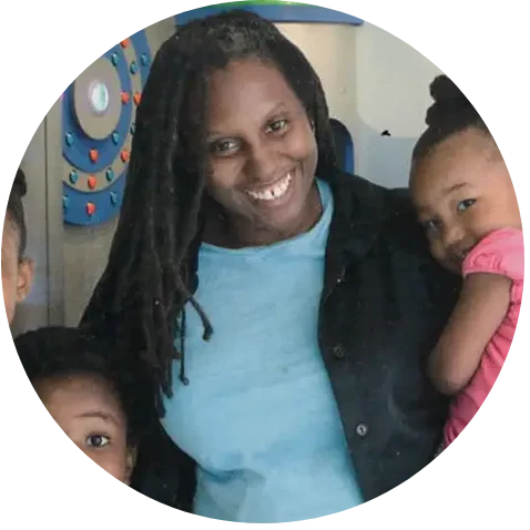 Smiling mother hugging her two children