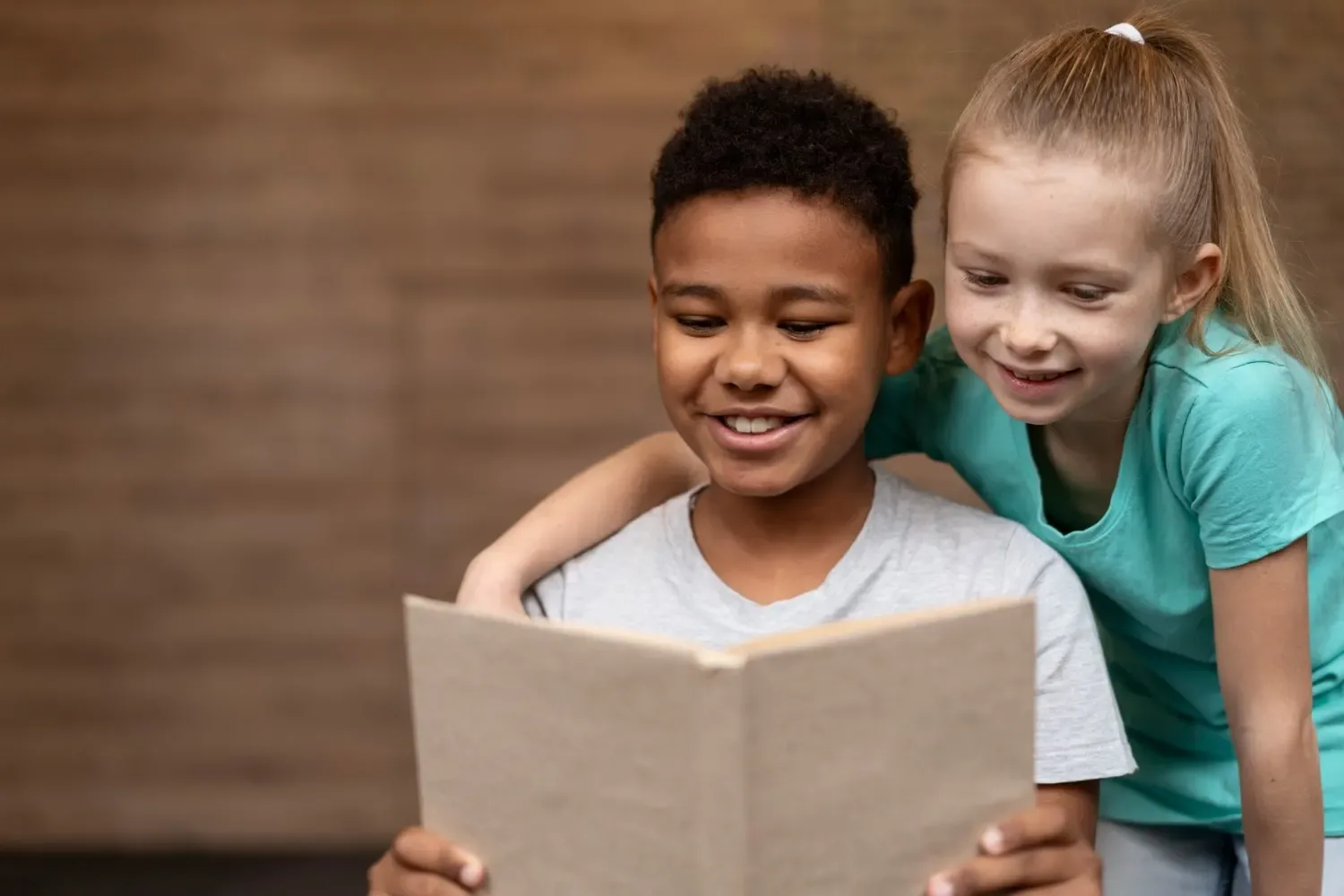 Two children reading a book together