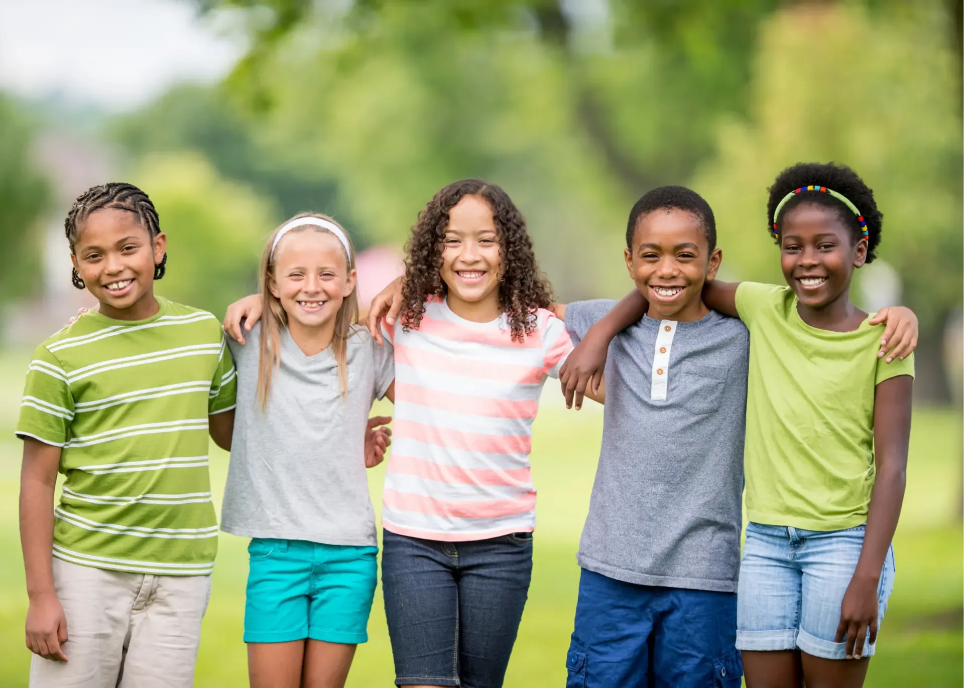 Five children standing together in a park