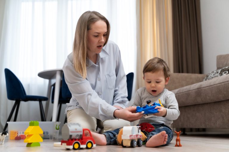 Mother playing with her toddler and toy trucks at home