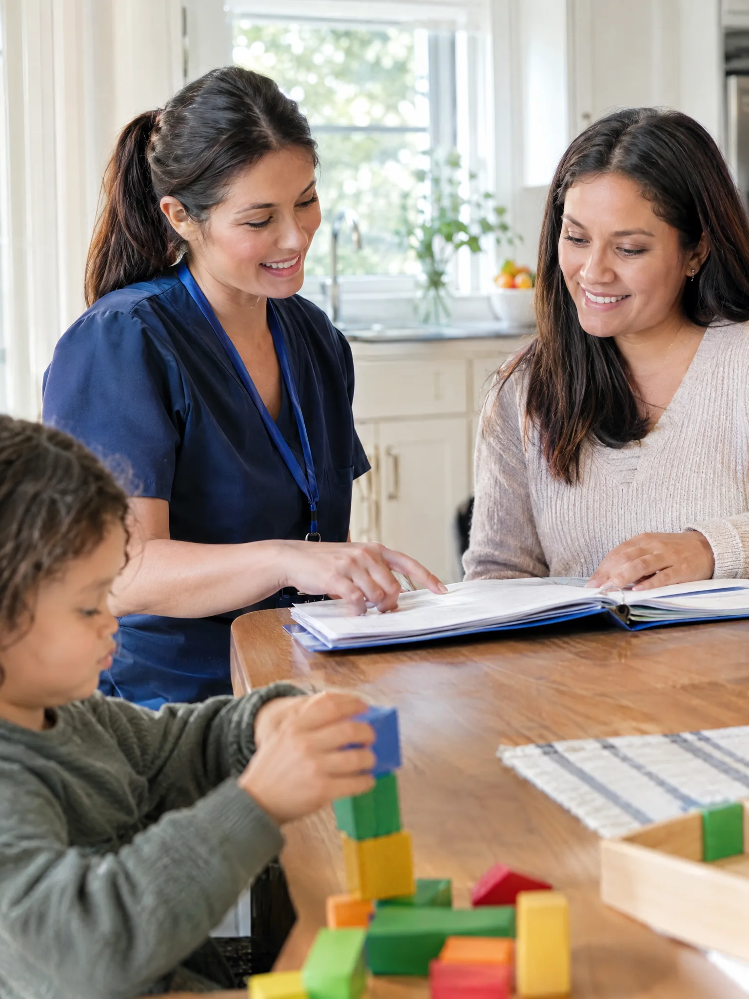 Nurse reviewing a care plan with a mother at the kitchen table
